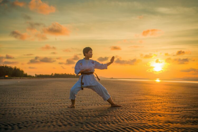 boy doing karate routines during golden hour